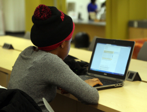 Political science junior Amanda Holmes is working on homework at the laptop bar in the James E. Shepard Library. Photo By Shakira Warren/ Echo Editor-In-Chief 