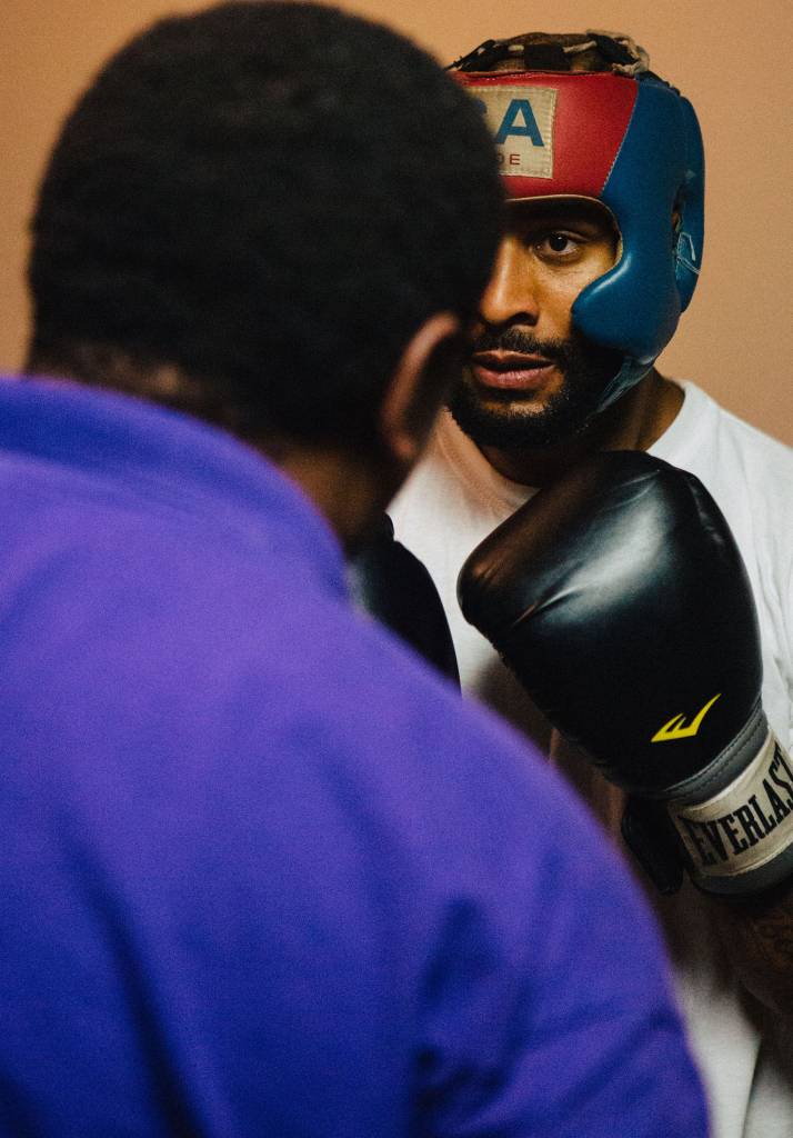 David Johnson, 28, concentrates on his form while preparing for combination punches with Bishop Arnold Harris. Bishop Harris helps David with words of encouragement. Photo by Bruce dePyssler/ Campus Echo Advisor