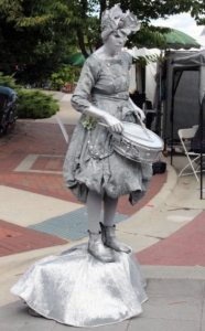 The Silver Drummer Girl played for tips as crowds walked by at the CenterFest Arts Festival on Saturday Sept. 24.